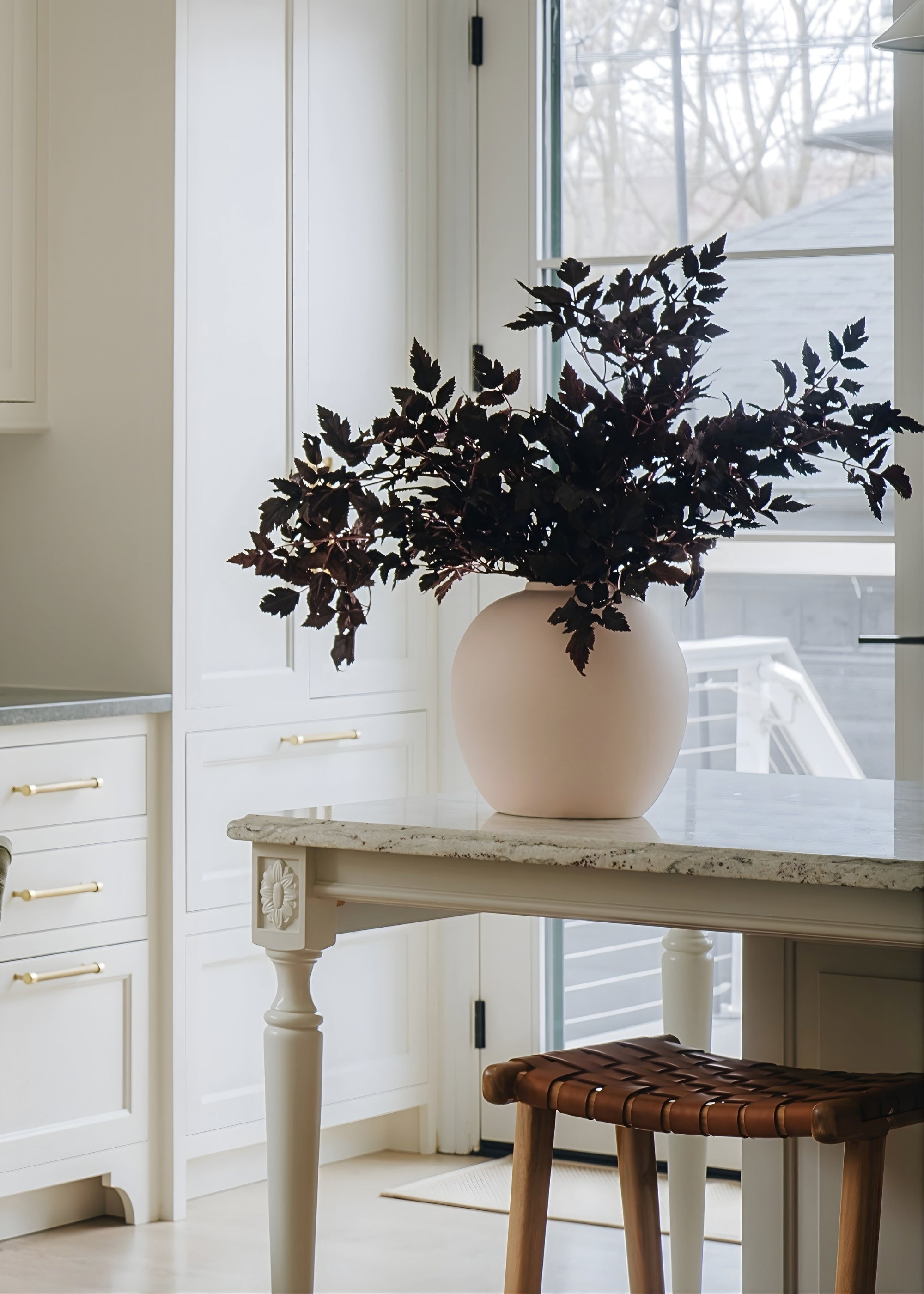 Matte cream vase styled as table centerpiece