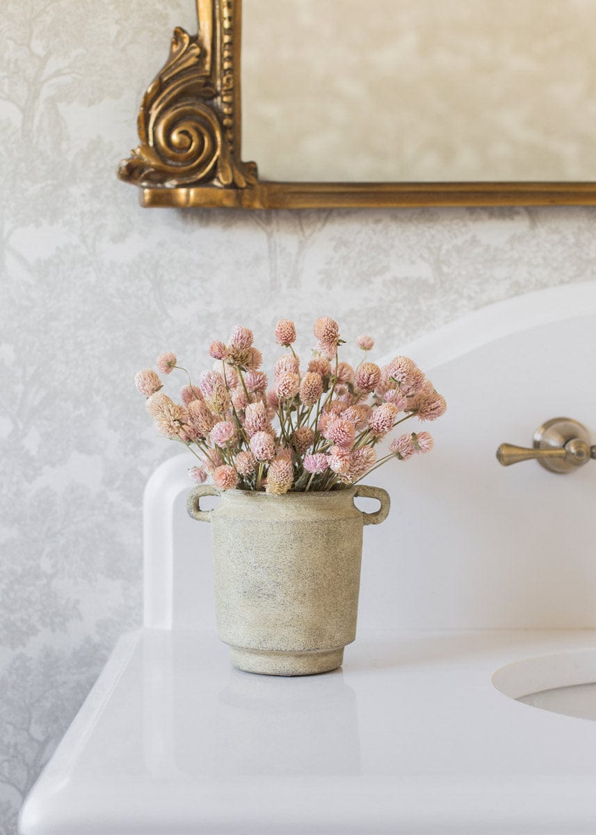 Soft pink dried flowers styled in farmhouse vase