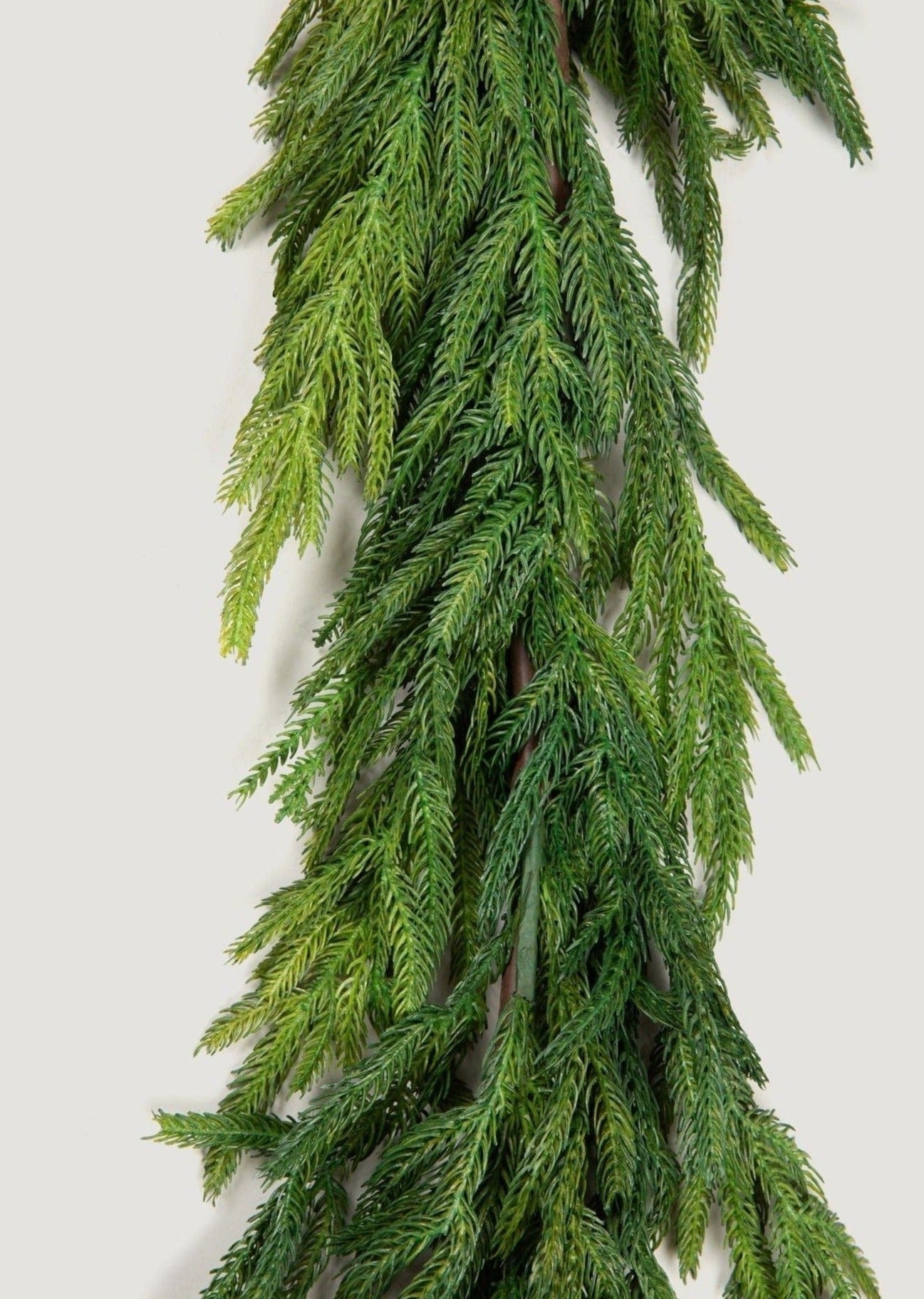 Extended faux Norfolk garland for staircase styling