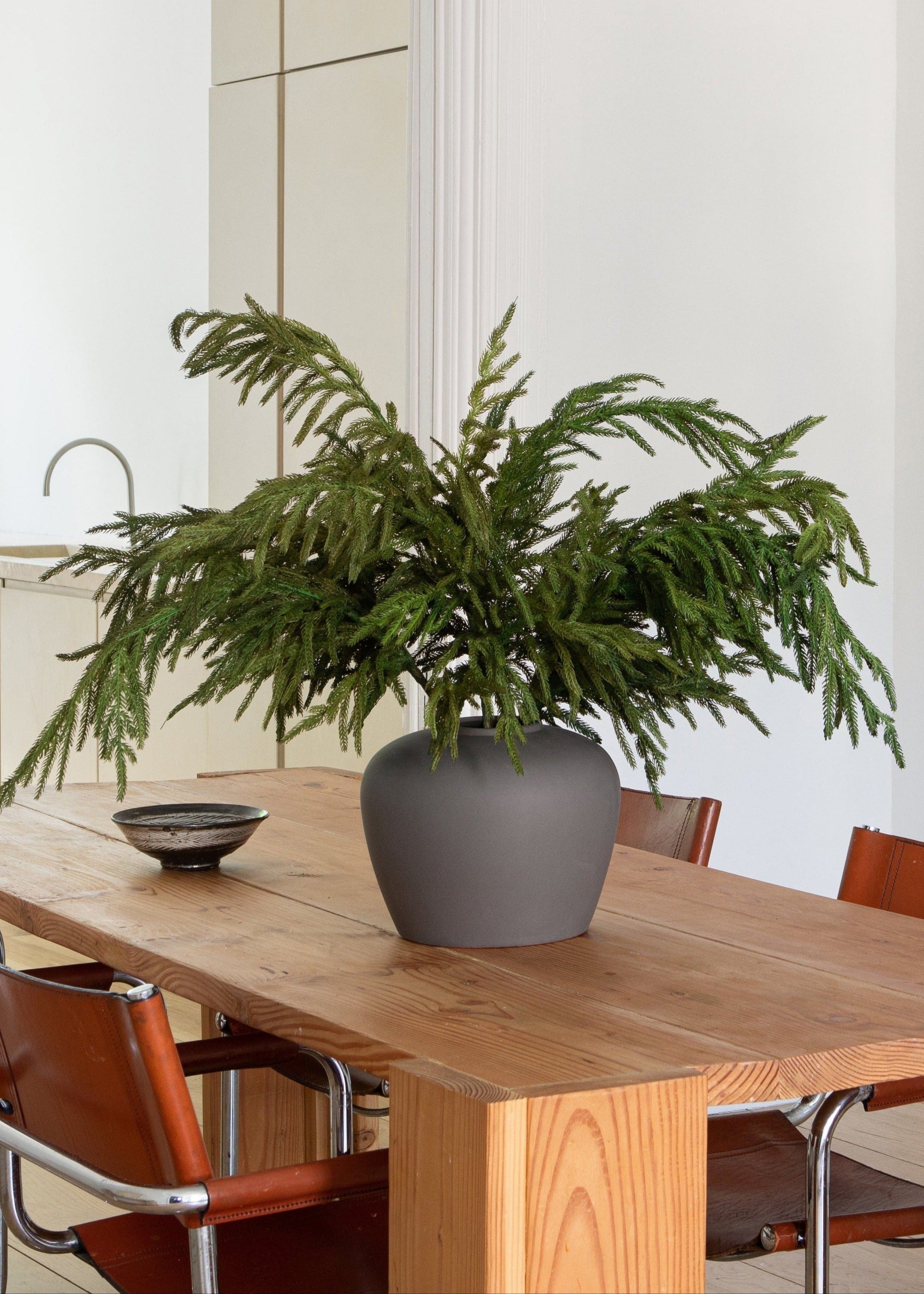 Lifelike pine stem for winter centerpiece arrangement