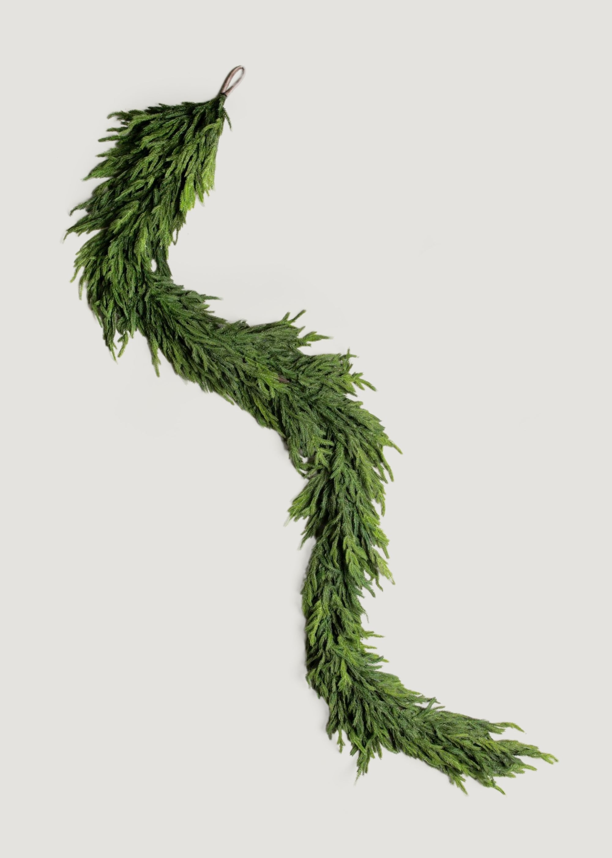 Artificial pine garland styled on staircase railing