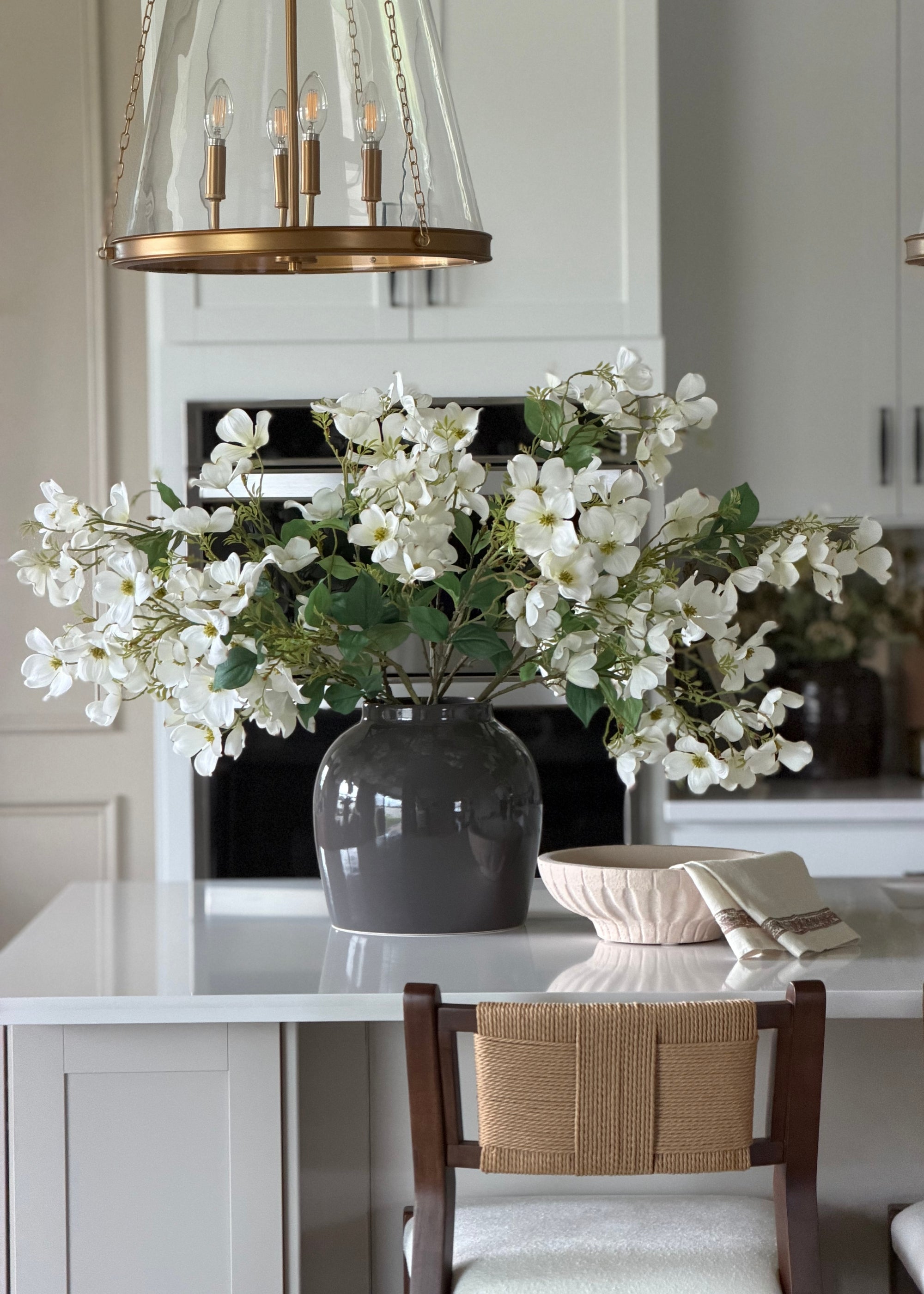 Faux dogwood branch with white blossoms for home styling