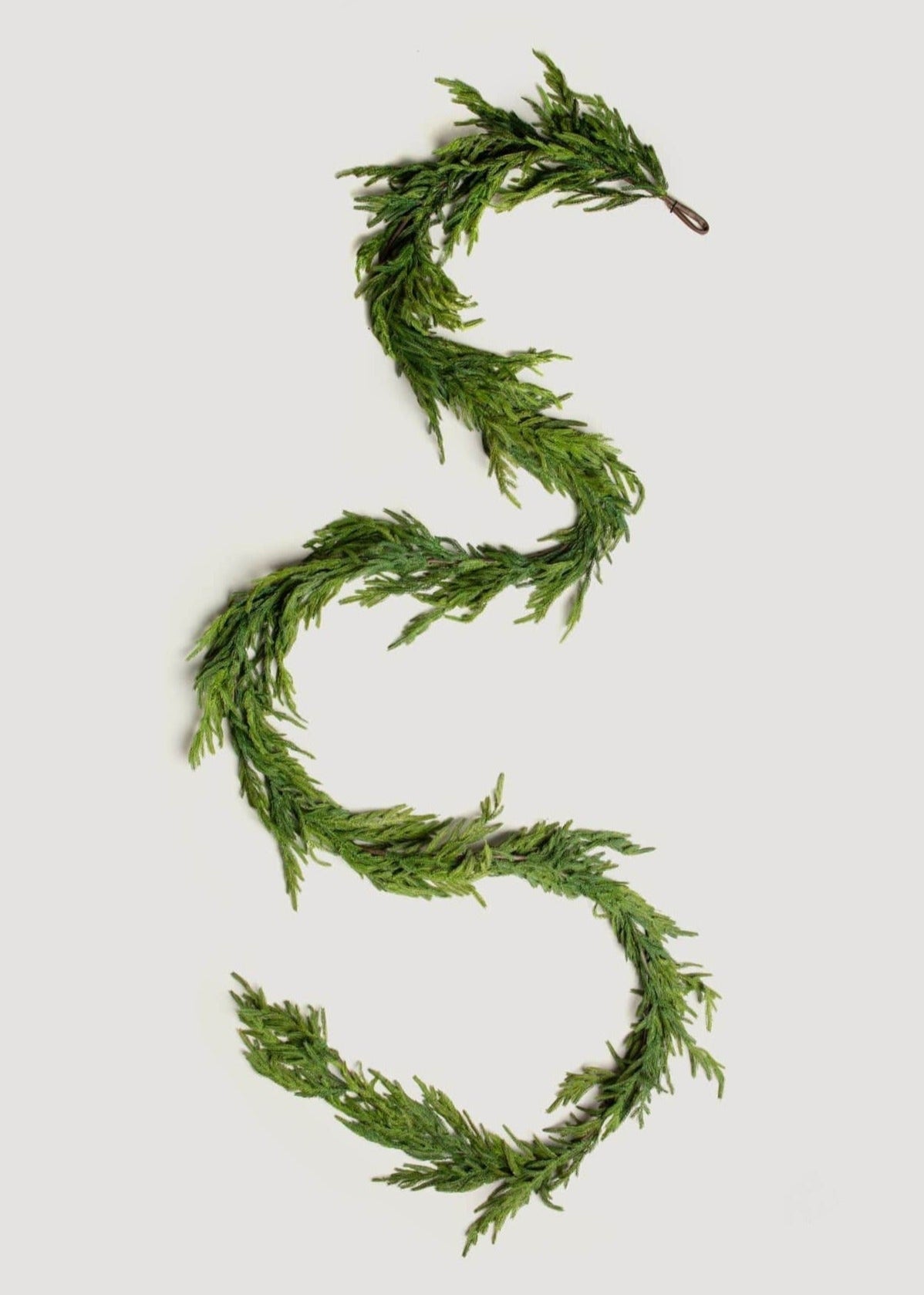 Artificial pine garland styled across mantel decor